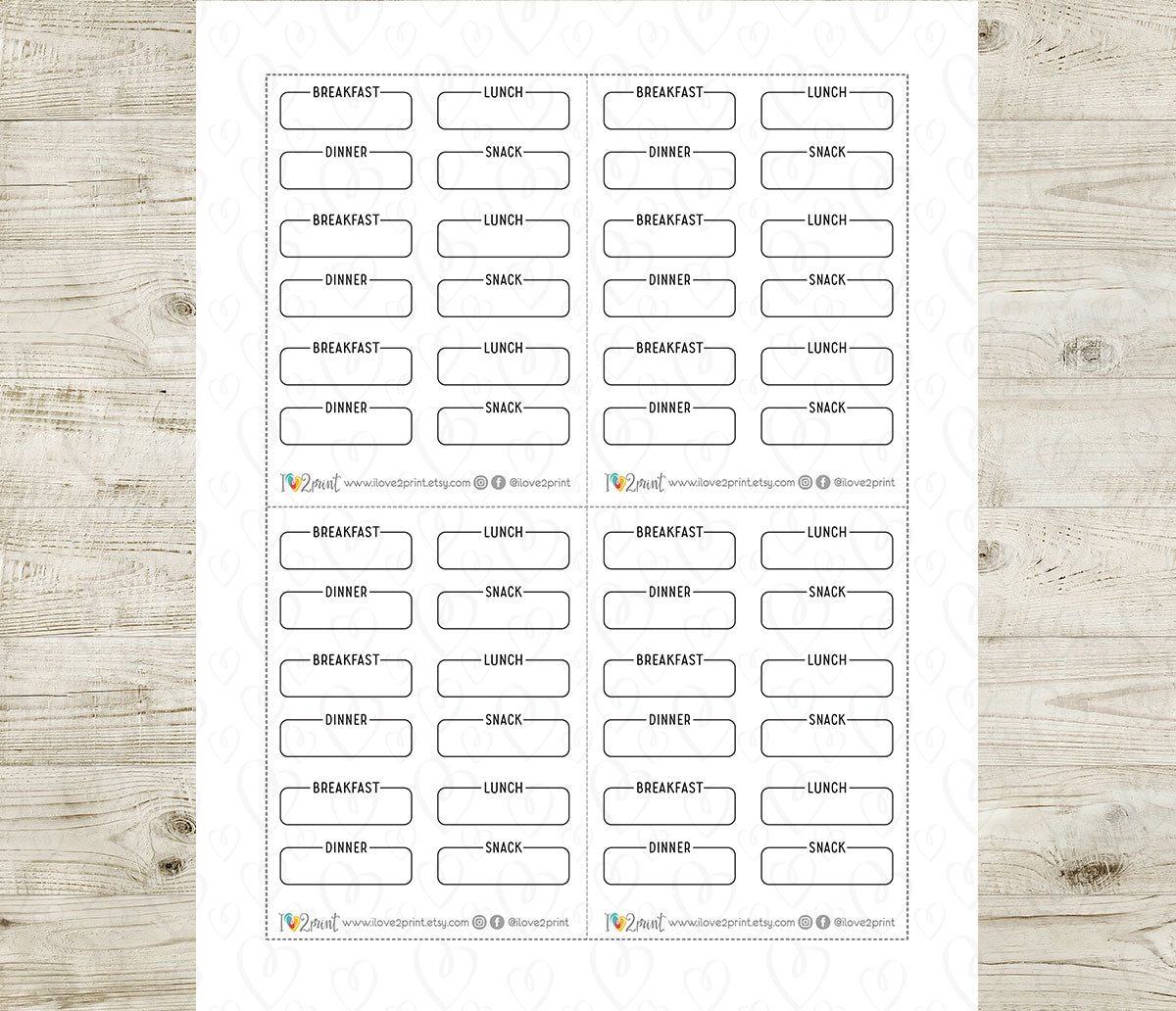 Sheet of pre-printed breakfast, lunch, snak and dinner labels on a wooden surface