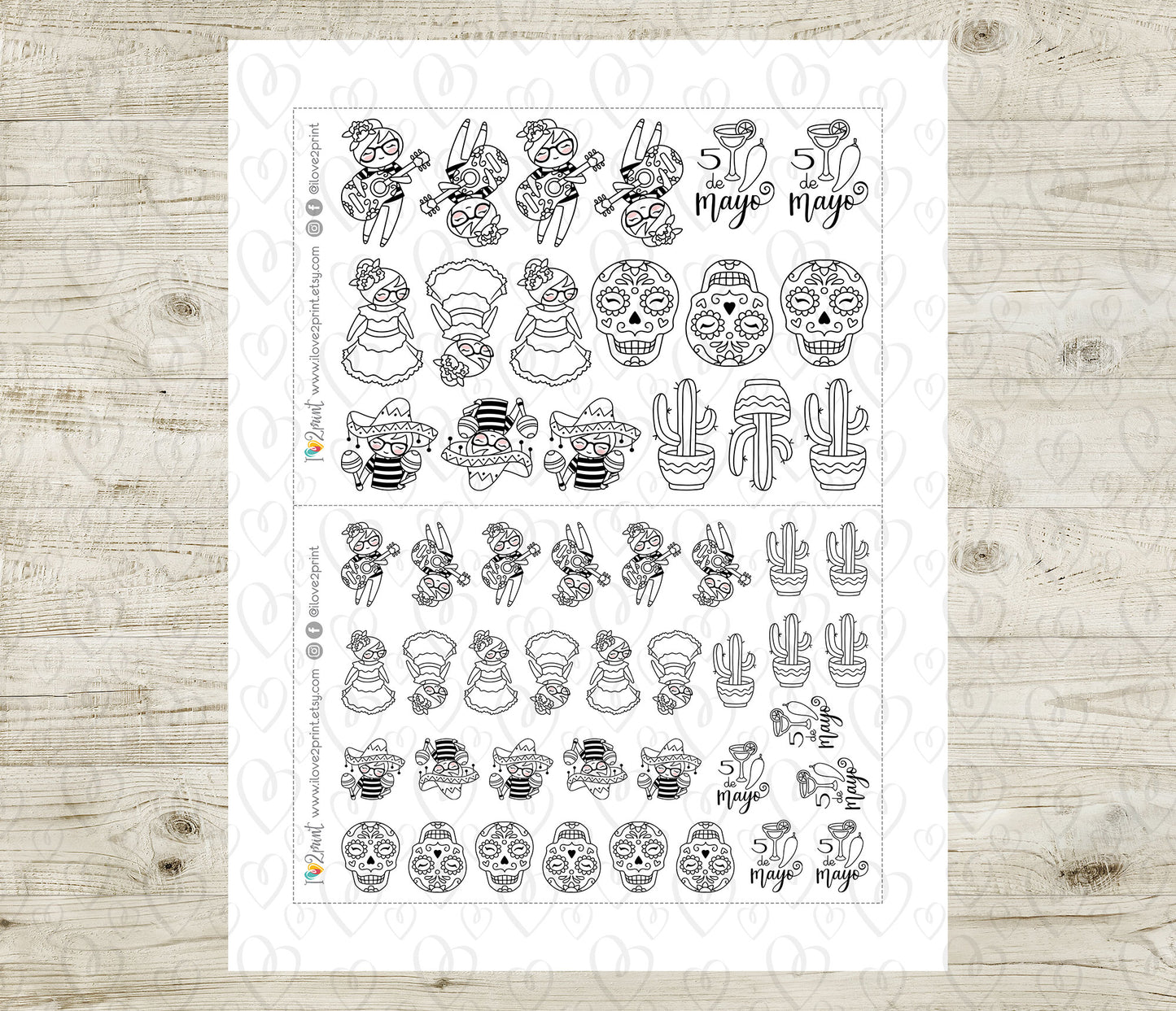 Sheet of black and white planner stickers on a wooden surface