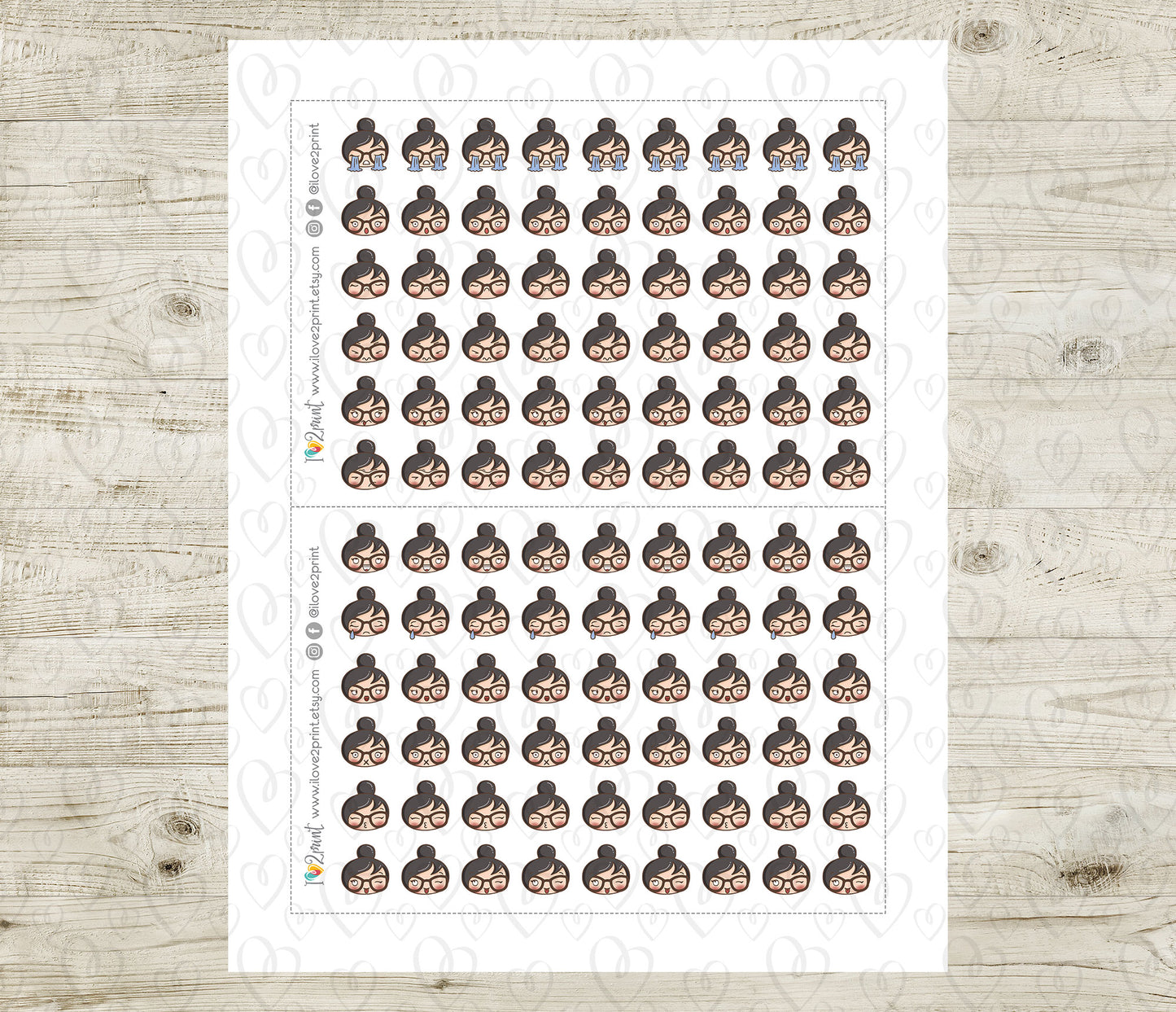 Sheet of planner stickers with a woman's face emoji on a wooden surface