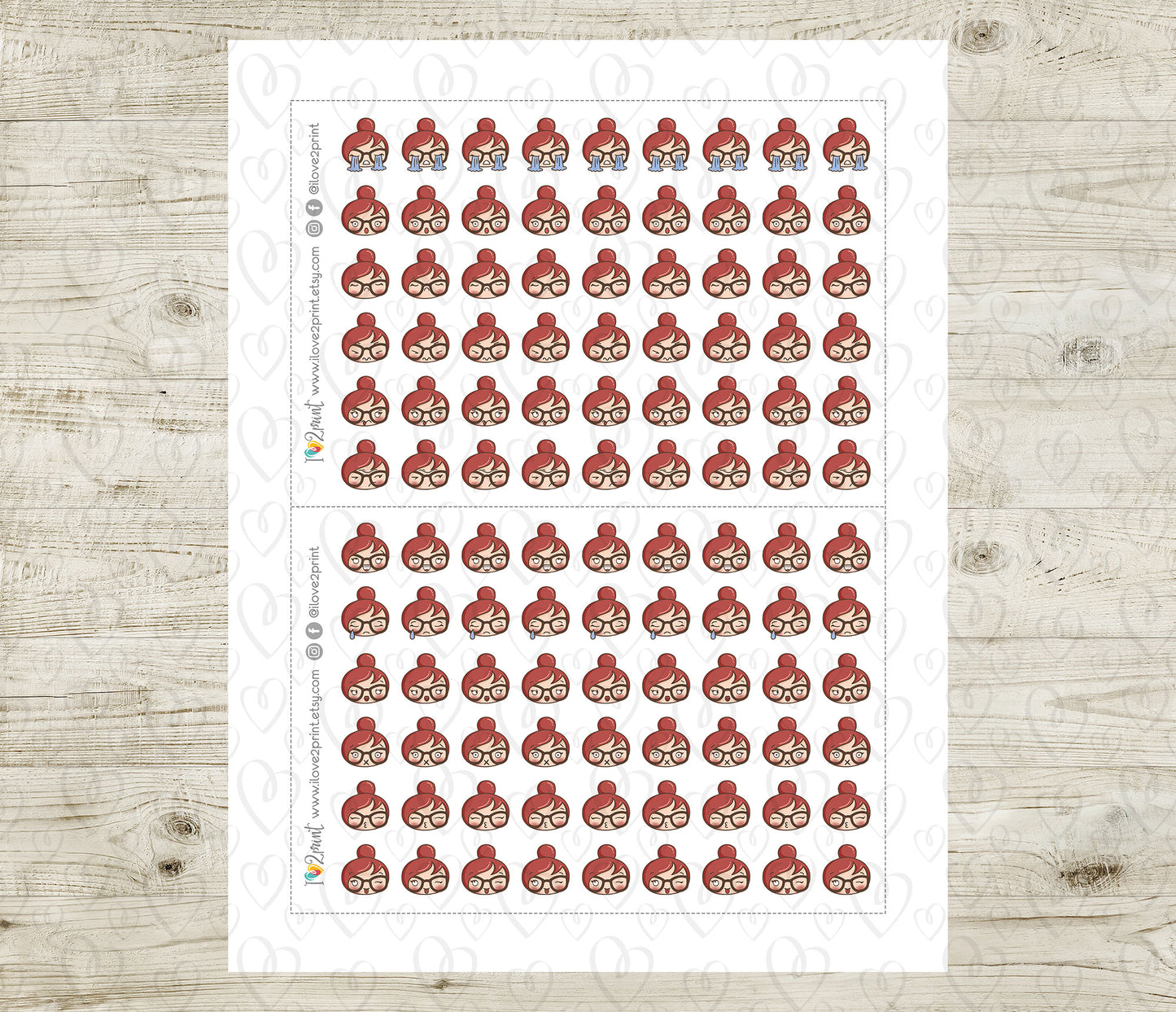 Sheet of red hair emojis and various feelings stickers on a wooden surface