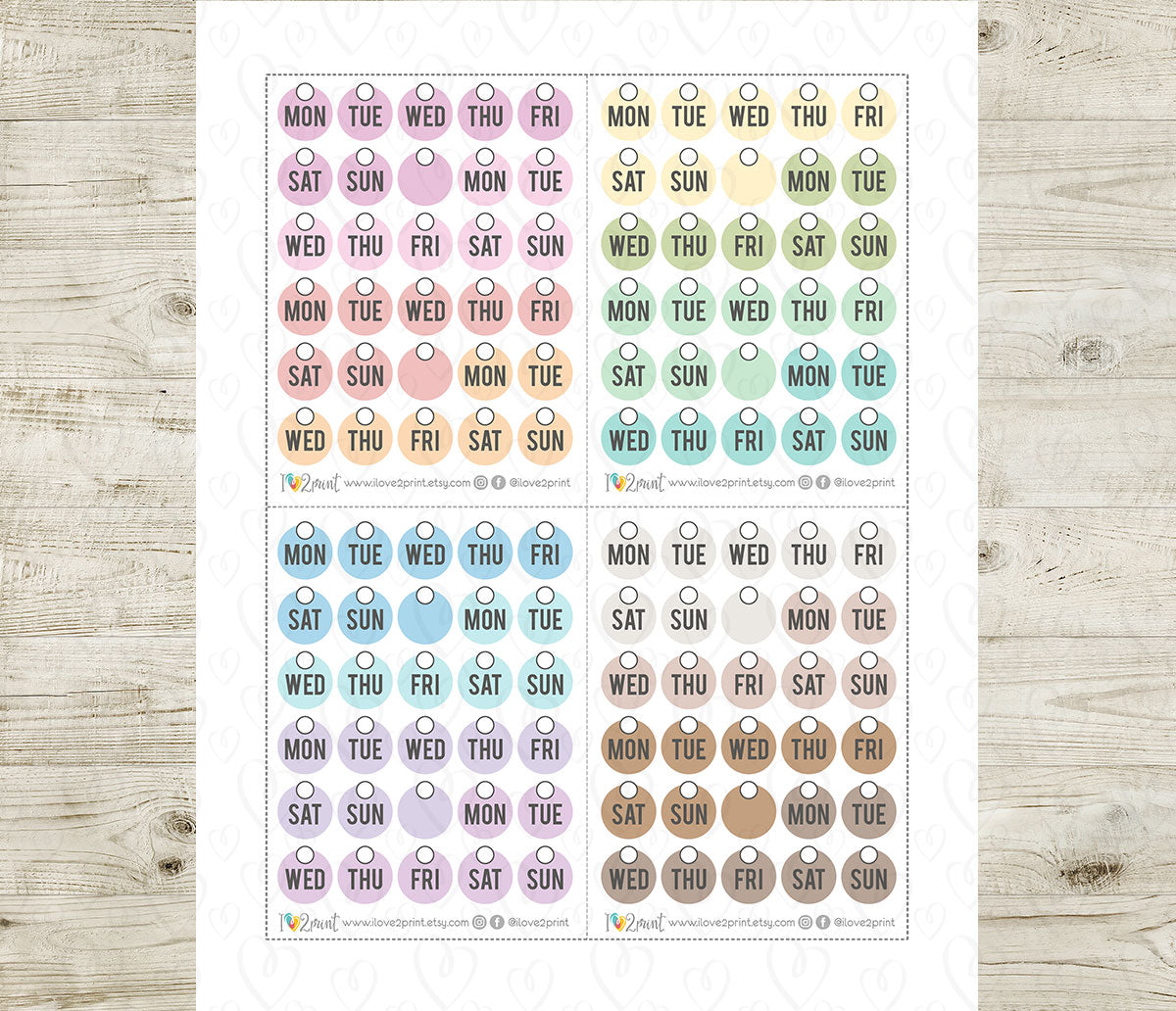 Sheet of pastel day-of-week labels on a wooden surface