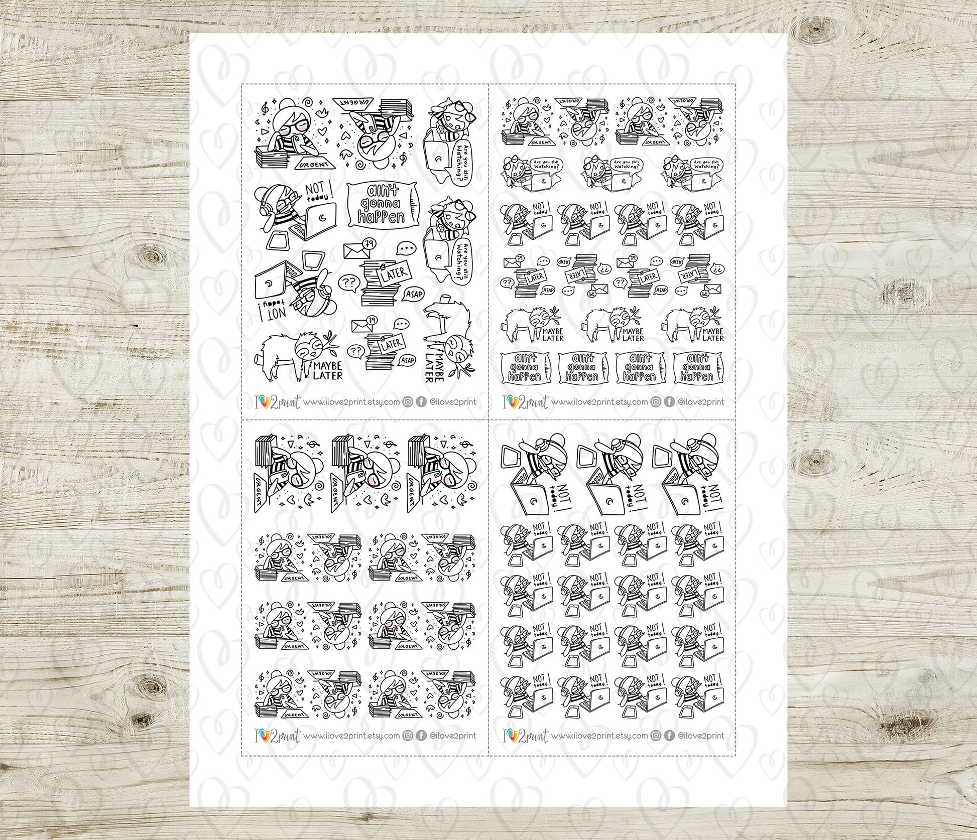 Sheet of black and white planner stickers on a wooden surface