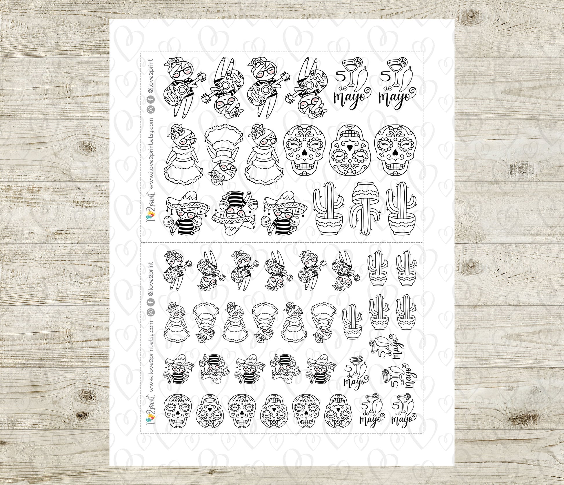 Sheet of black and white planner stickers on a wooden surface