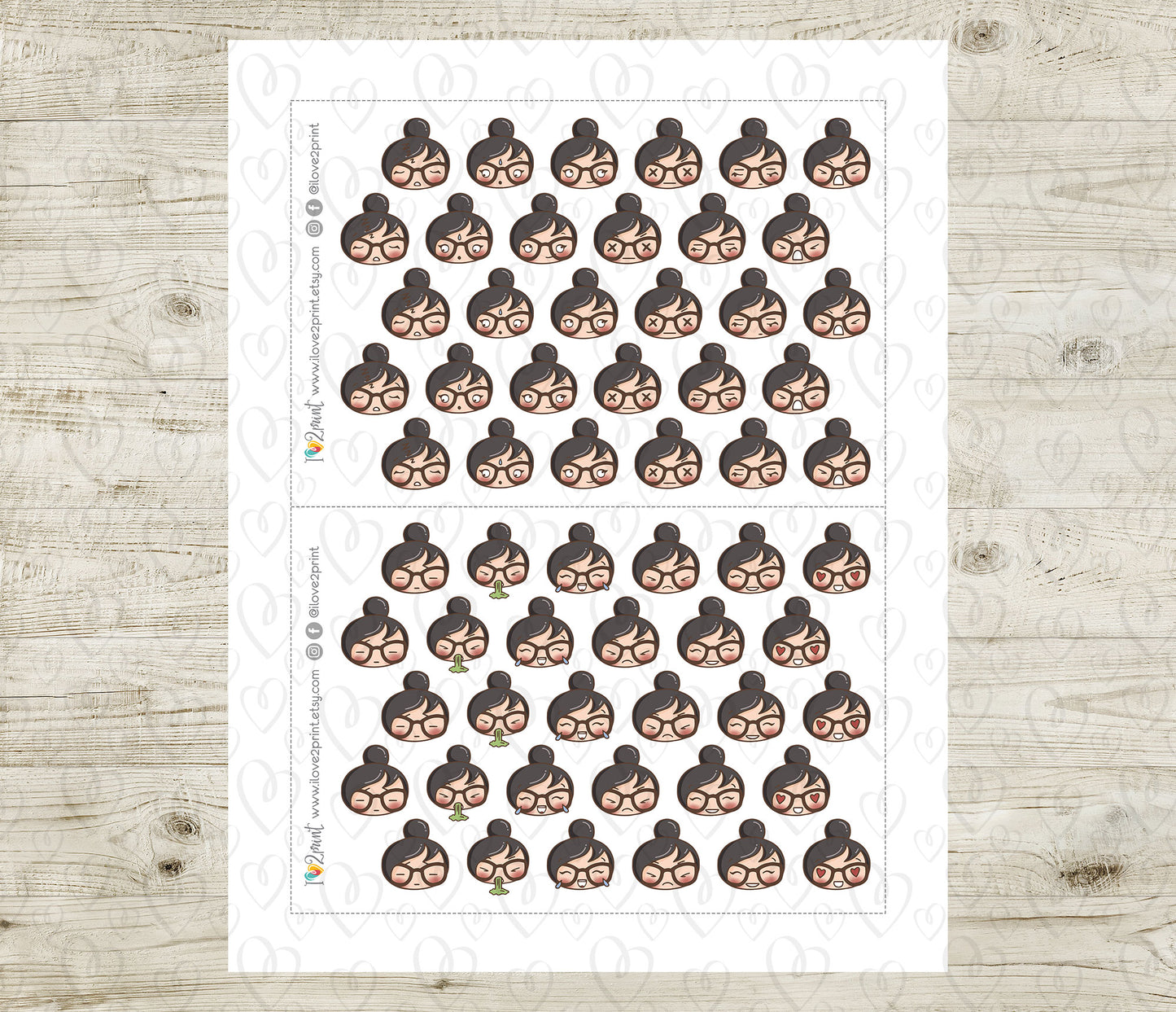 Sheet of planner stickers with woman face emojis on a wooden surface