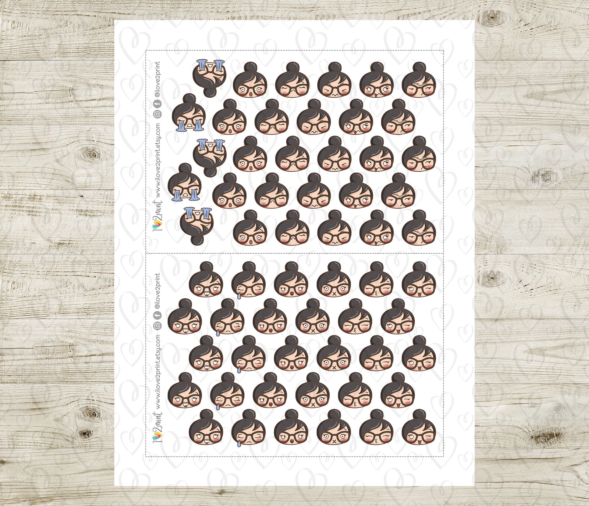 Sheet of planner stickers with a woman's face feelings design on a wooden surface