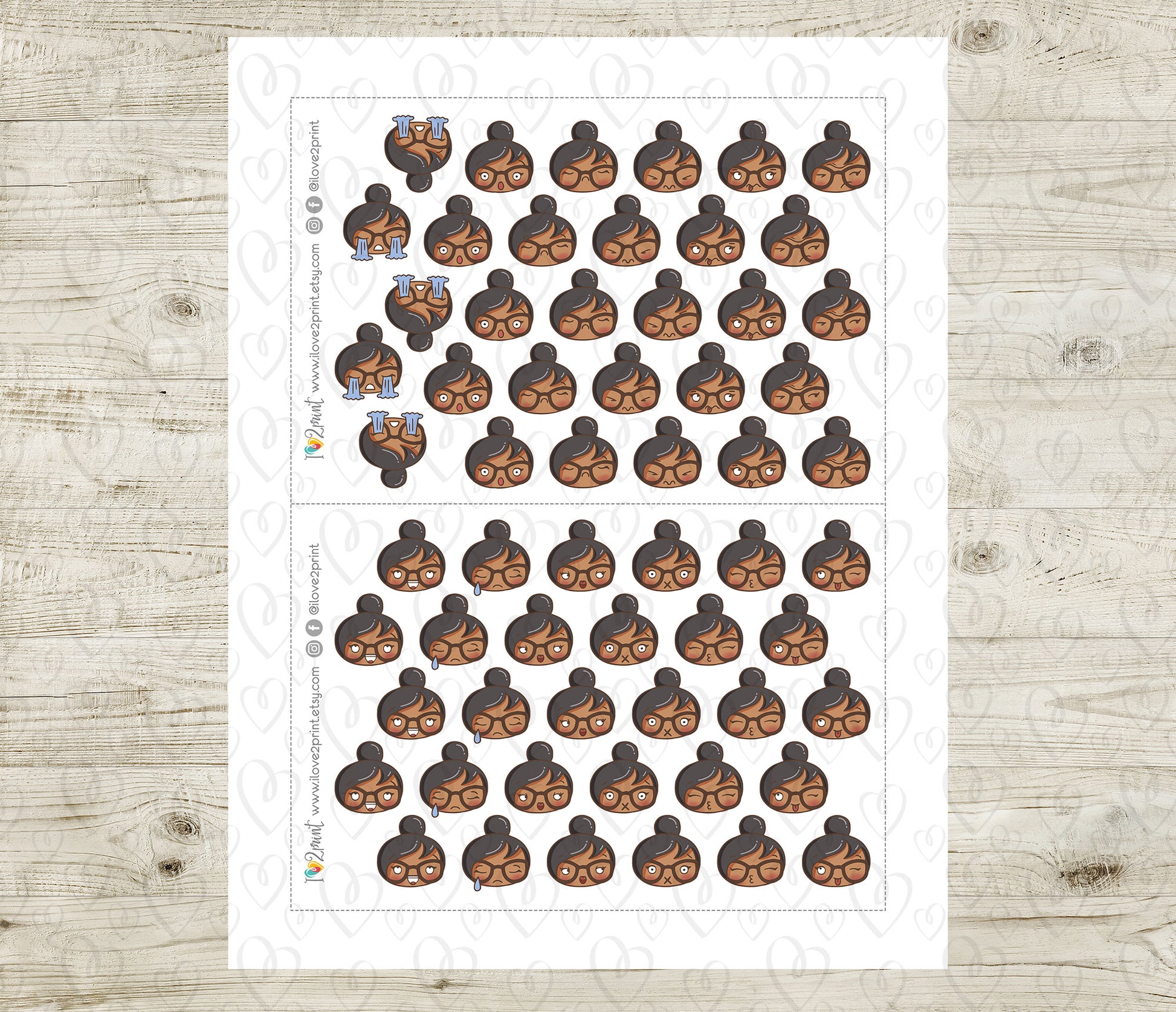 Sheet of planner stickers with a brown skin girl various moods on a wooden surface