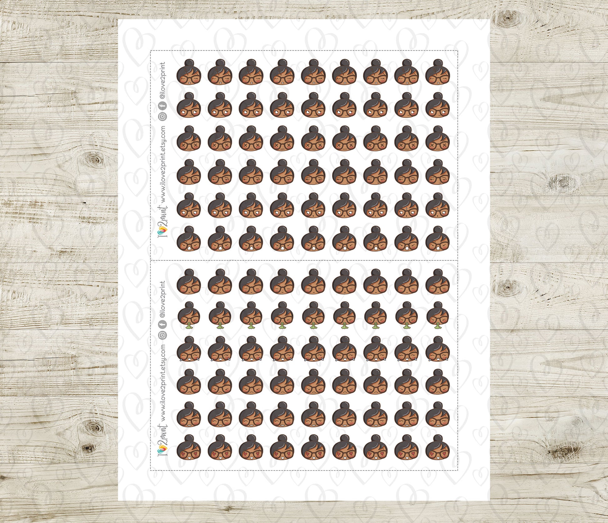 Sheet of small stickers with a person's face on a wooden surface