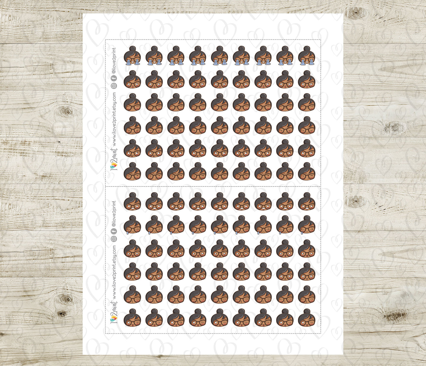 Sheet of planner stickers brown skin girl emoji head with different moods on a wooden surface