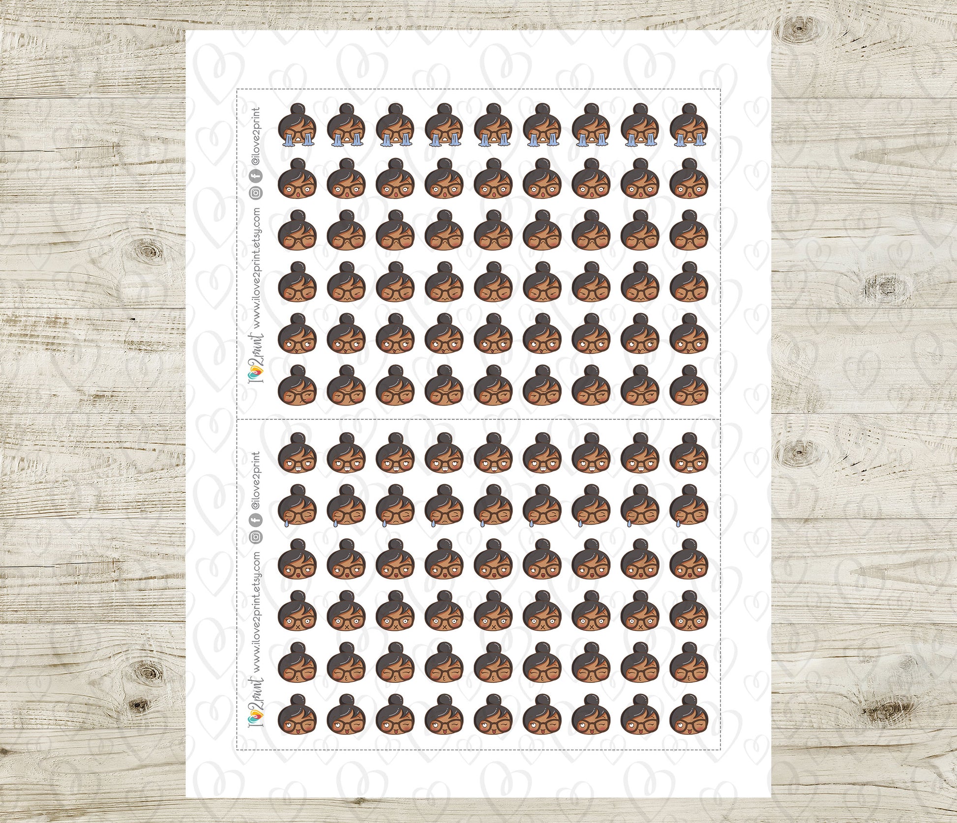 Sheet of planner stickers brown skin girl emoji head with different moods on a wooden surface