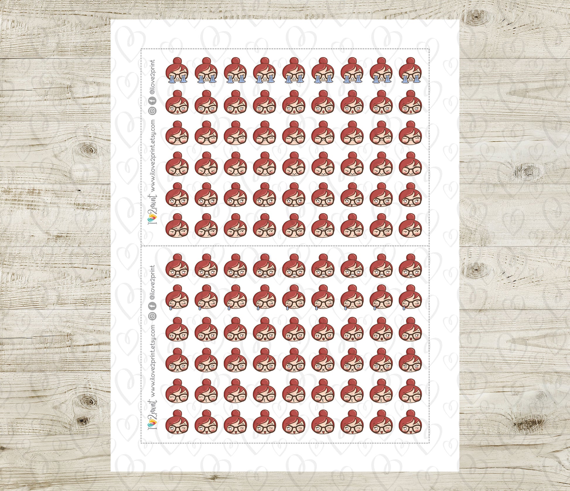 Sheet of red hair emojis and various feelings stickers on a wooden surface