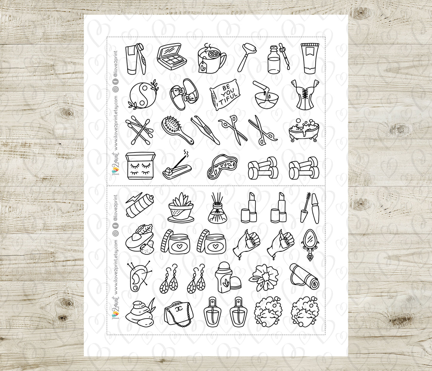 Sheet of black line art beauty icons on a white background, placed on a wooden surface.