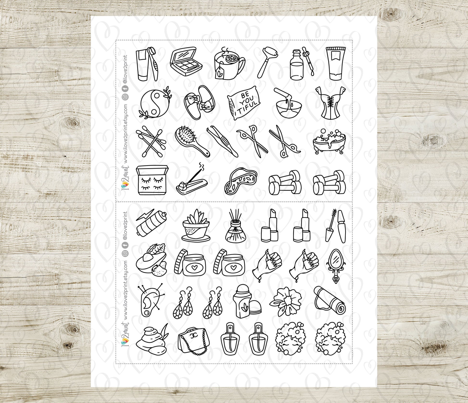 Sheet of black line art beauty icons on a white background, placed on a wooden surface.