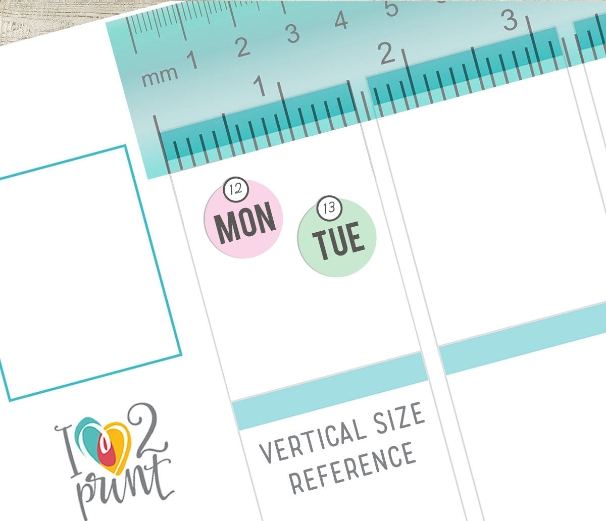 Planner stickers with 'MON' and 'TUE' labels on Vertical Planner page on a white background with a ruler at the top.