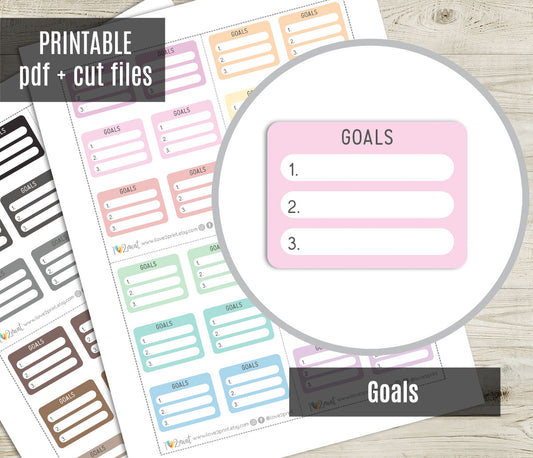 Set of printable goal-setting planner stickers on a wooden surface with 'Printable pdf + cut files' text.