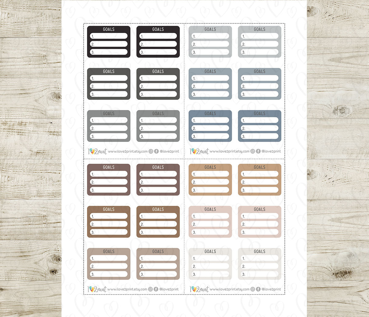 Set of goal tracker labels in various neutral colors on a wooden surface