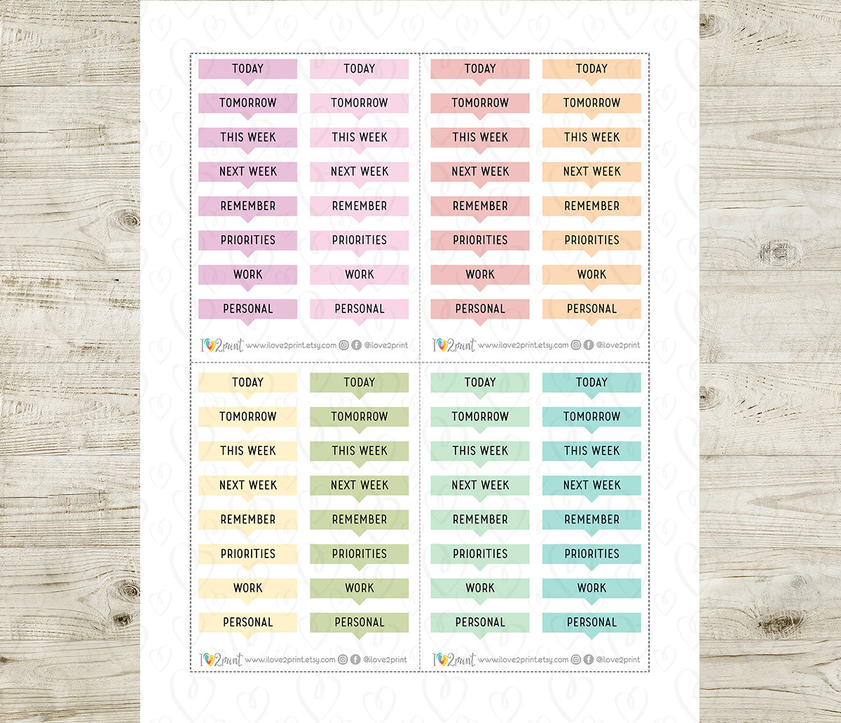 Sheet of planner stickers with various text labels on a wooden surface