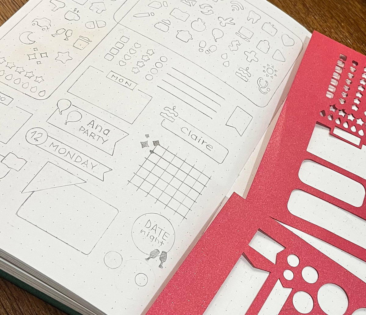 A bullet journal with red stencil sheets and examples of use