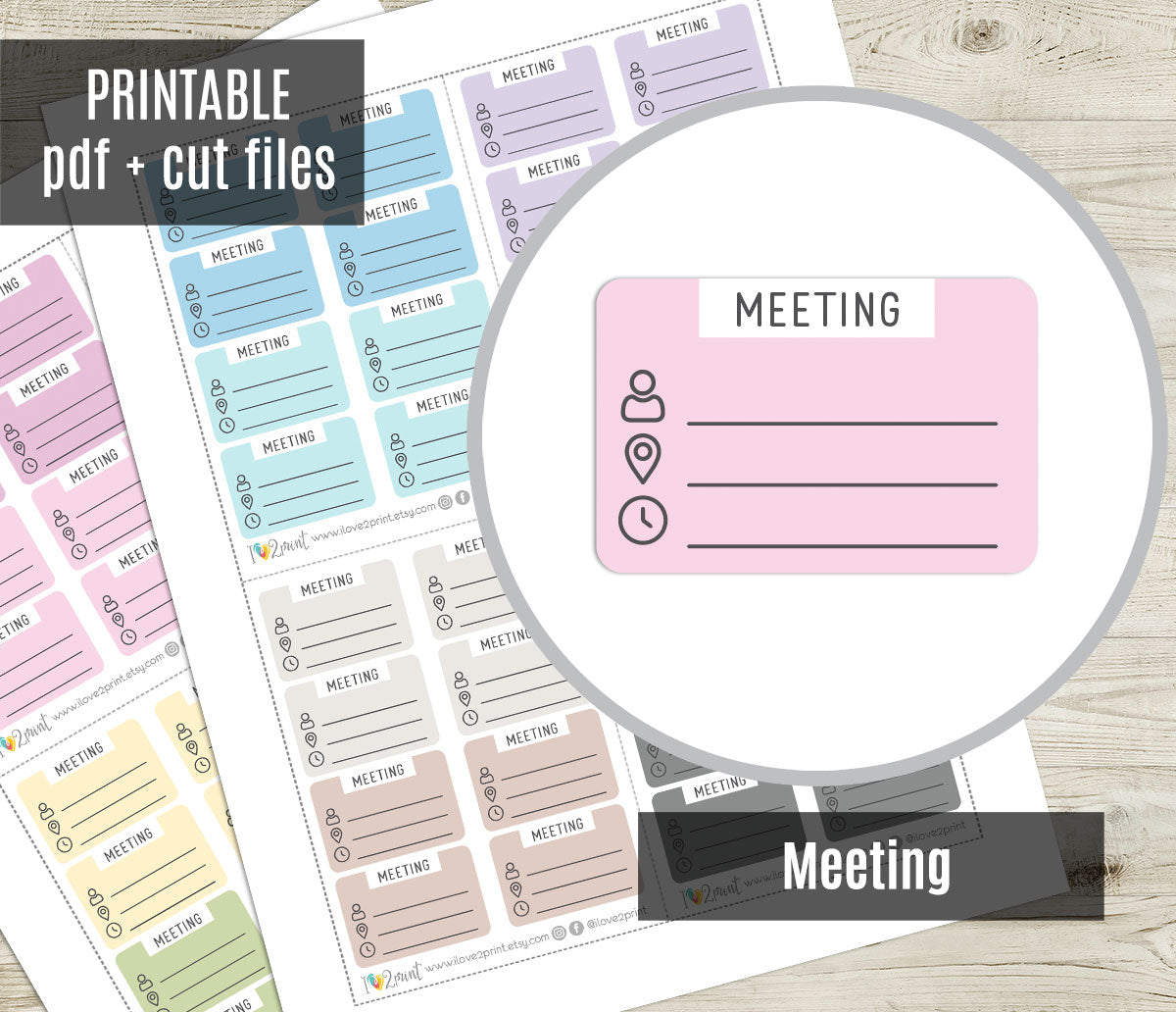 Meeting planner stickers with various colors on a wooden surface.