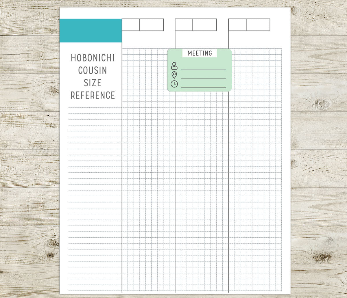 Meeting sticker on a Hobonichi cousin size reference sheet on a wooden surface