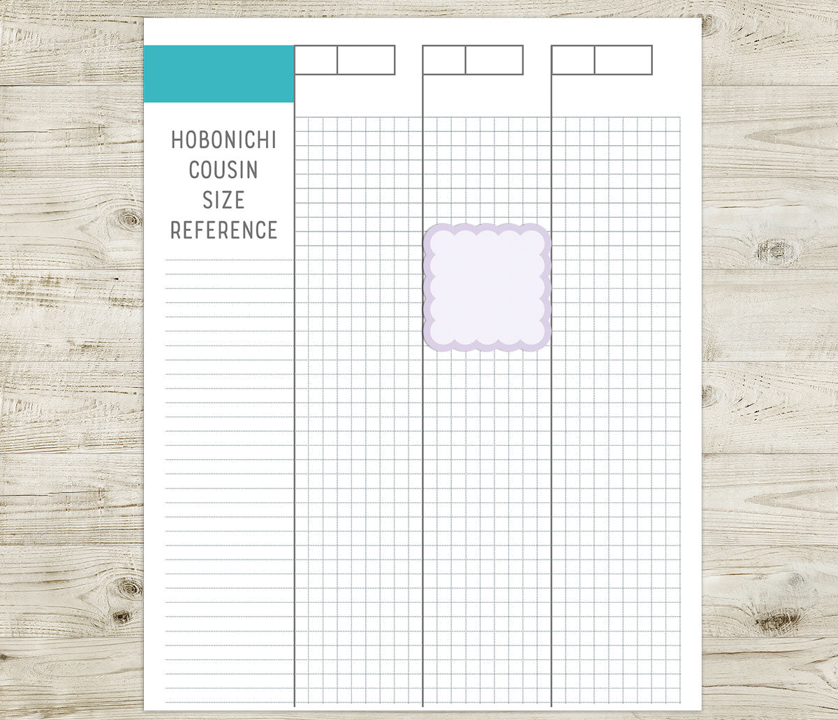 Hobonichi cousin size reference sheet with a scallop box sticker on a wooden surface