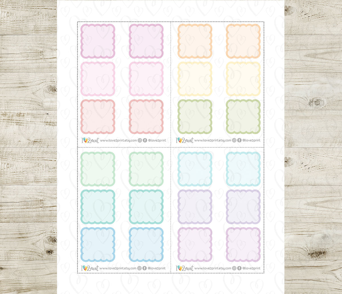 Sheet of pastel color scallop boxes stickers on a wooden surface