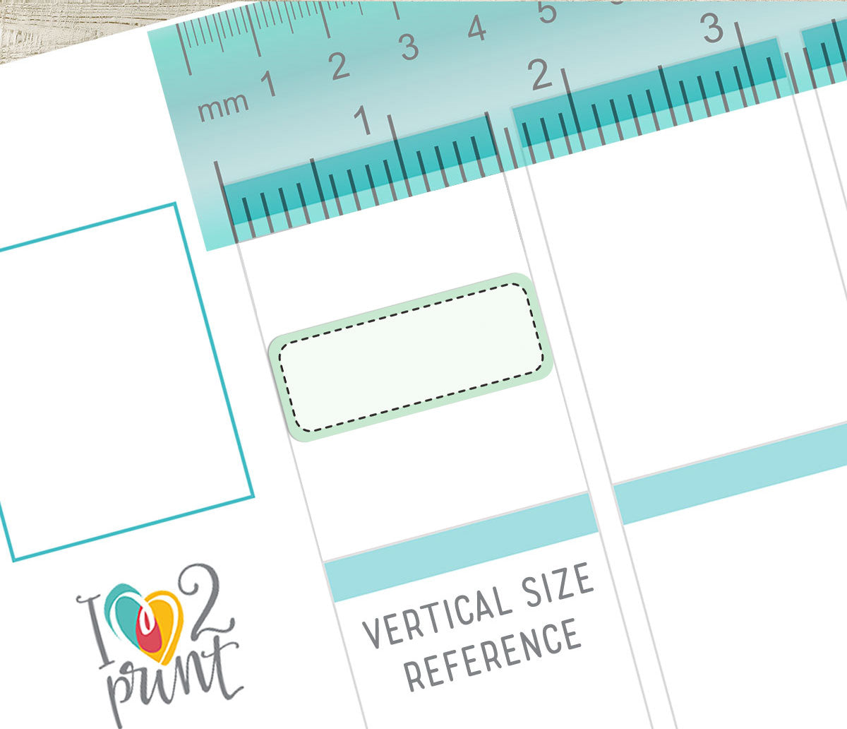 Sheet of paper with label and ruler for vertical size reference, featuring a stitched box sticker