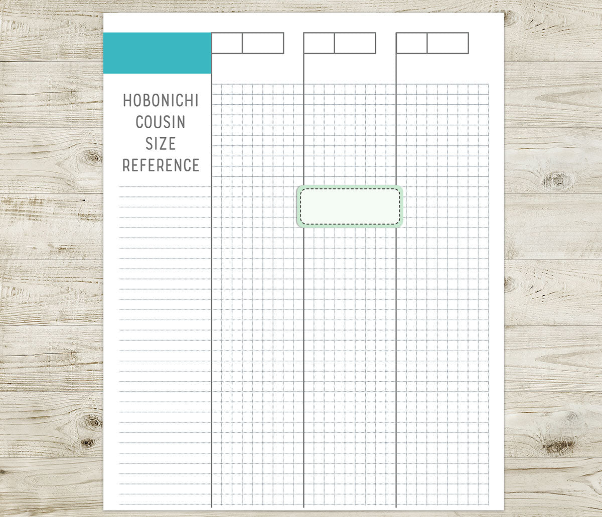 Hobonichi Cousin size reference sheet with a stitched box sticker on a wooden surface
