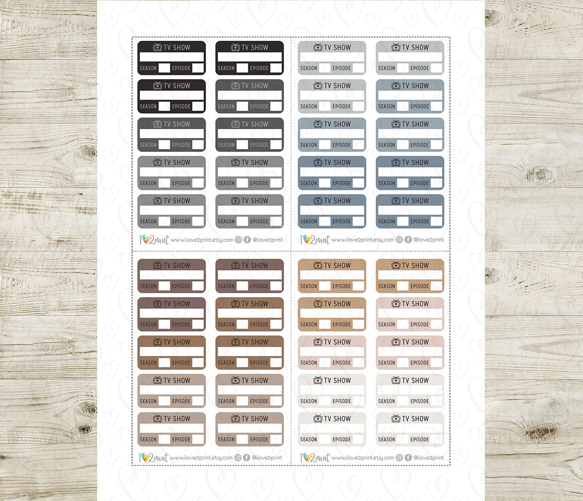 Sheet of TV show labels in various neutral colors on a wooden surface